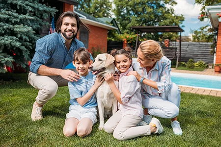 family outside playing with dog tick and mosquito free yard